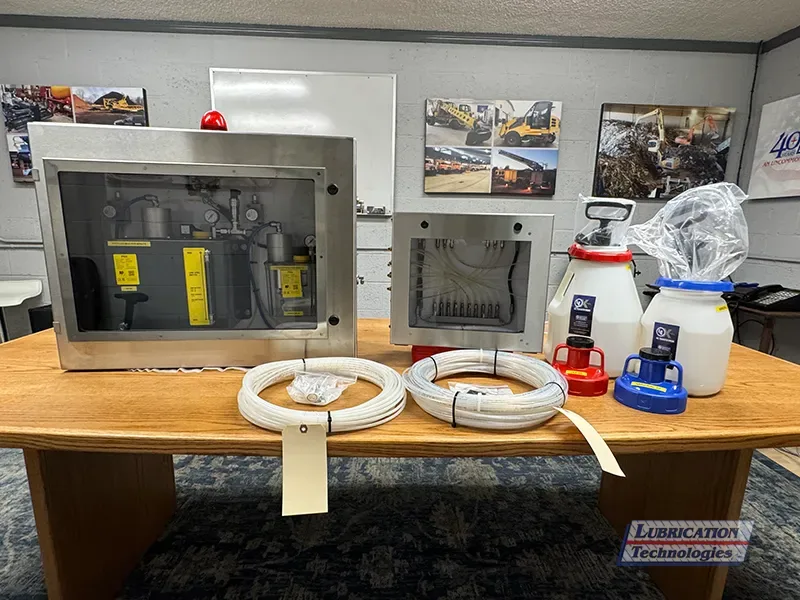 Food-grade chain lubrication system kit with stainless steel enclosures and Xpel lubricant storage containers