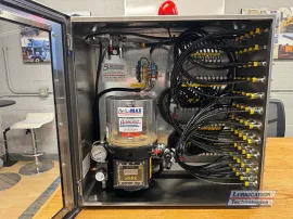 ReliaMAX™ 4 kg automatic lubrication system mounted inside a stainless steel NEMA 4X enclosure for a paper machine press section application